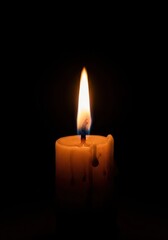 Warm, soft glow of a single candle wick burning brightly in a completely dark room, creating a peaceful and calm atmosphere, flame, darkness, fire