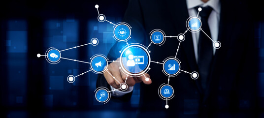 A businessman interacts with a vibrant digital interface, showcasing various connections and icons that represent technology, networking, and innovation in a corporate setting. Tessel