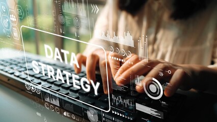 Hands typing on keyboard with data strategy visuals and digital overlay in modern workspace environment. Asymptotic smart data analytic.