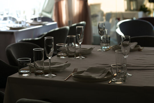 Beautiful table setting with dishes,in a restaurant,light-shadow pattern and style