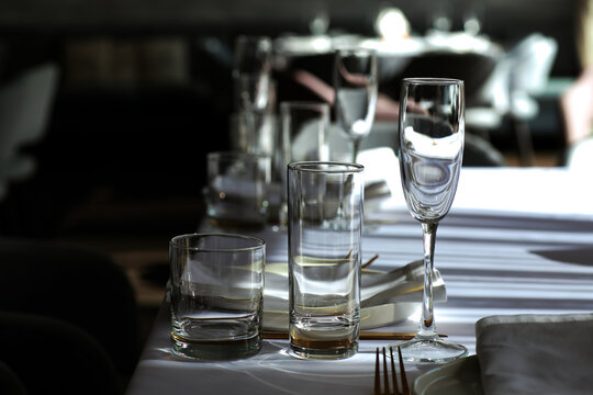 Beautiful table setting with dishes,in a restaurant,light-shadow pattern and style