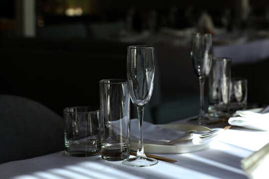 Beautiful table setting with dishes,in a restaurant,light-shadow pattern and style