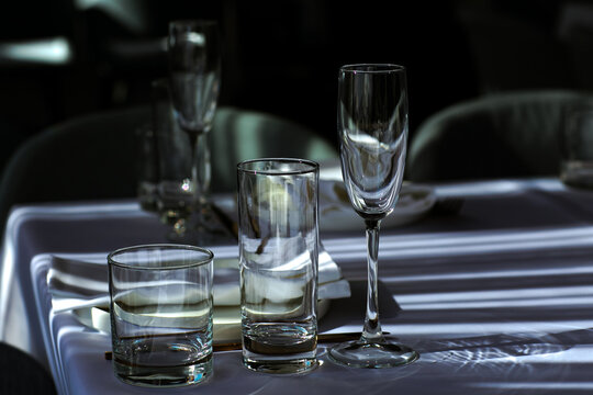 Beautiful table setting with dishes,in a restaurant,light-shadow pattern and style