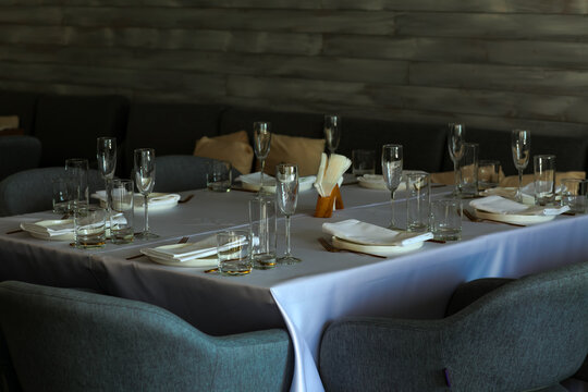 Beautiful table setting with dishes,in a restaurant,light-shadow pattern and style