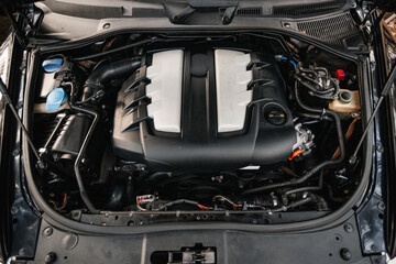 Car with open hood close up to camera. Maintenance in auto repair shop. Car service, repair,...