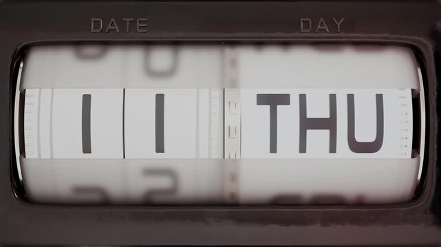Retro mechanical rolling calendar with cylinder drums spinning fast to show passing days and dates for a full month using an odometer style scrolling mechanism.