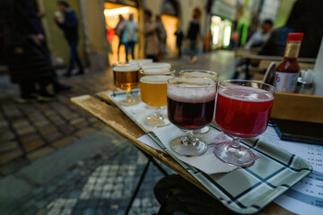 Outdoor Beer Tasting On A Busy City Street At A Prague Cafe &ndash; Colorful Glasses On a Tray
