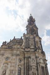 Obraz premium Cathedral tower stands tall against a blue sky with clouds in a historic city of Dresden