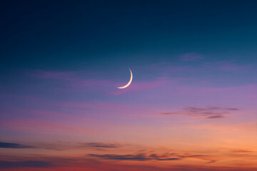 Serenity of a crescent moon shining brightly in a colorful twilight sky filled with soft purple and orange hues over a peaceful evening horizon
