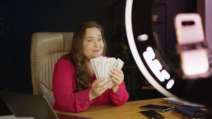 Successful businesswoman recording financial course video on smartphone for blog