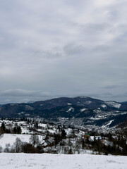 Mystical snowy Carpathian peaks under cloudy skies