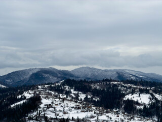 Fototapeta premium Mystical snowy Carpathian peaks under cloudy skies