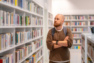  hipster  man reading a book on the library floor