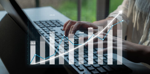 A focused business professional engages with financial data on a laptop, showcasing graphs and trends that signify growth in a modern corporate environment. Impute