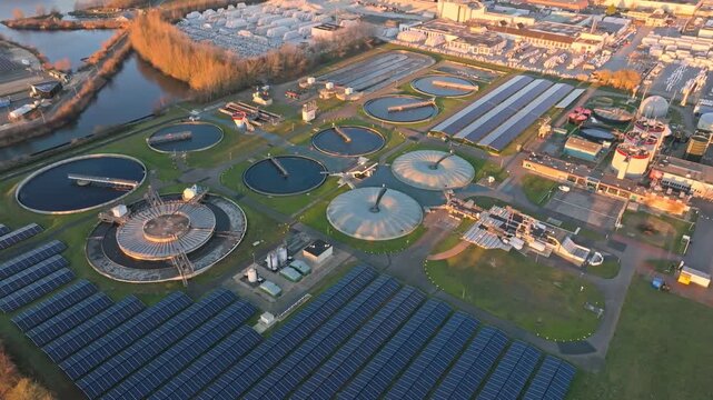 Aerial view modern wastewater treatment plant with sedimentation tanks and solar panels
