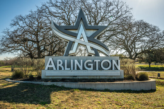 Statue Sign of Arlington City Logo With Star In Grass Near Trees in Arlington, Texas