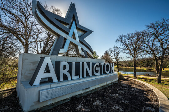 Close Up of Statue Sign of Arlington City Logo With Star In Grass Near Trees in Arlington, Texas