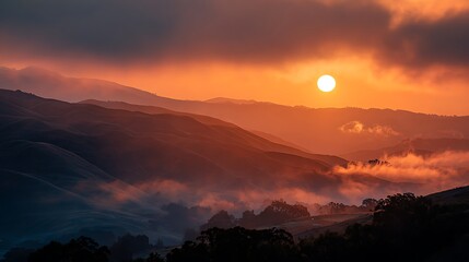 Dramatic sunset over rolling hills with clouds and trees in a serene landscape scene at dusk
