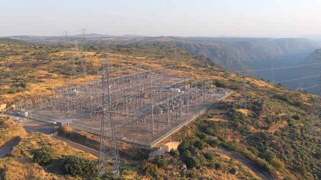 Electrical substation with power pylons and power lines at a hydroelectric power plant (Aldeadavila). Aerial video