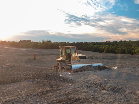 CAT bulldozer pushing and leveling soil at an active construction site, showing earthmoving work, heavy equipment operation, and site preparation. Aurora, Ontario, Canada - August 23, 2015