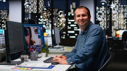 Graphic developer working with photo editing software at the office, digital media production with professional tools. Dual monitors for productivity in the graphic design industry. Camera B. © DC Studio