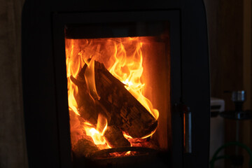 a burning stove with firewood.