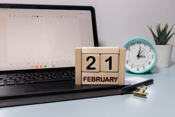 Minimalist white wooden block perpetual calendar displaying FEBRUARY 21