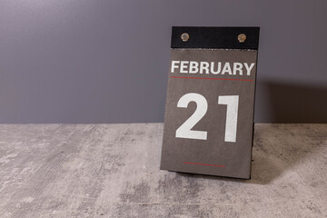 Minimalist white wooden block perpetual calendar displaying FEBRUARY 21