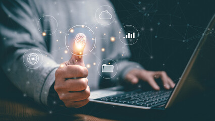 Cyber security and biometric authentication concept. Man using laptop with fingerprint and digital icons. Secure data access, cloud technology, identity verification and modern business protection.