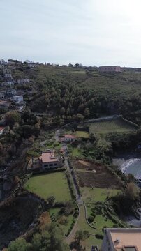 Vertical drone footage of the enchanted Saracen tower in San Nicola Arcella Calabria once home to an English horror writer overlooking the Tyrrhenian Sea