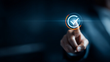 Business finger pressing approval check icon representing compliance verification quality control and successful confirmation in digital workflow.
