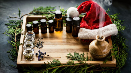 Holiday workspace features essential oils, candles, and festive decorations for celebration