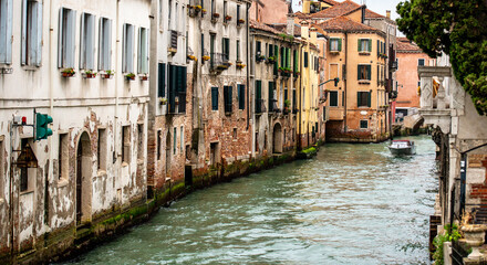 Naklejka premium Boat Is Floating Down Old Canal