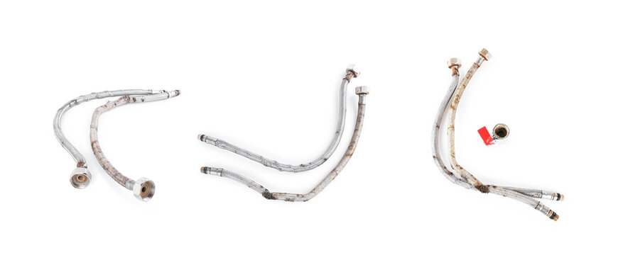 Old rusty flexible water hoses and valve isolated on white. Set of worn, corroded braided metal plumbing pipes showing damage and decay for repair concepts.