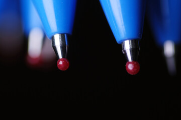 Macro shot of new ball pen with red ball ends