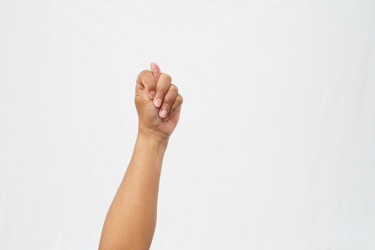 Left hand clenched into a fist with the thumb between index and middle fingers (fig sign). Isolated on a white background. Bold cultural gesture or symbol