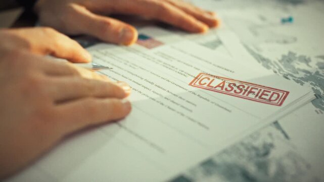 A civil servant in an official capacity examines a confidential state document concerning cooperation between two nations, stamped with a high-security mark