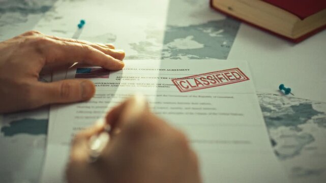 A male government official scrutinizes a confidential interstate treaty document bearing a high-level security classification seal in a restricted archive