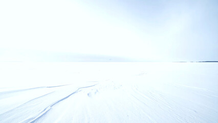 Vast snowy winter landscape with bright sky and horizon