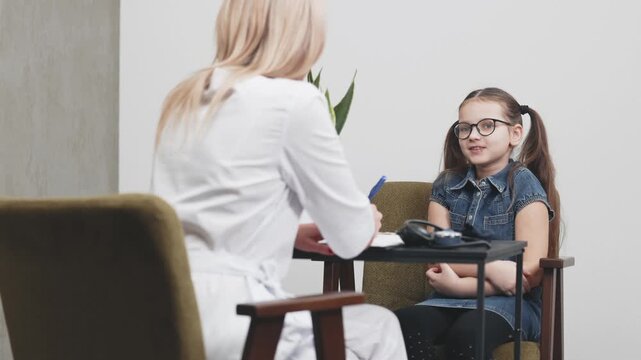 Healthcare professional interacts with a child during a pediatric consultation in a clinic. Concept child health, pediatric care, medical consultation