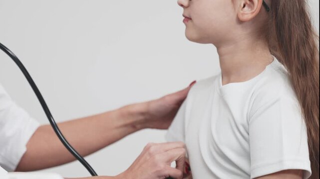 Pediatric healthcare professional examines a child&rsquo;s chest during a check-up in a clinic. Concept child health, preventive care, pediatric wellness