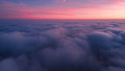 Colorful Sunset Over an Ocean of Clouds from Above.