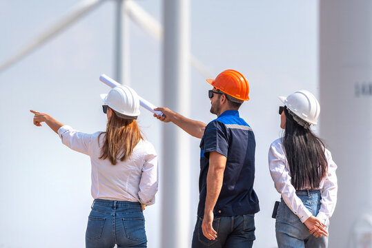 engineer team inspection check control wind power machine construction installation in wind energy factory. technician professional worker discussion check for maintenance electronic wind turbine