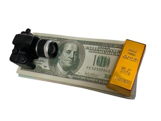 Camera, gold bar, and stack of U.S. dollar bills arranged together for financial concept imagery © MR HEPPY