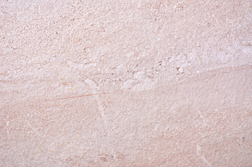 Fototapeta premium Pink marble, a roughly hewn natural stone with a distinctive pattern, close-up.