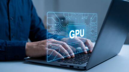 Person typing on laptop with glowing GPU circuit board graphic display showing advanced technology