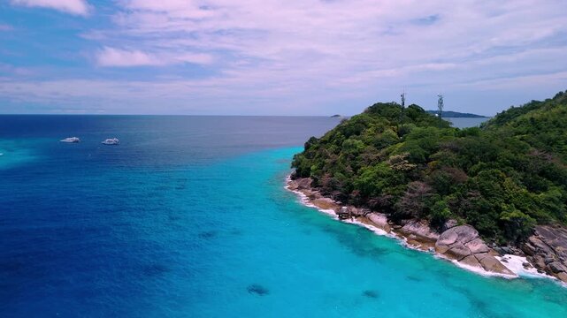 Natural tropical island scenery at the Similan Islands, Thailand, with turquoise sea, granite rock formations, and dense green forest.