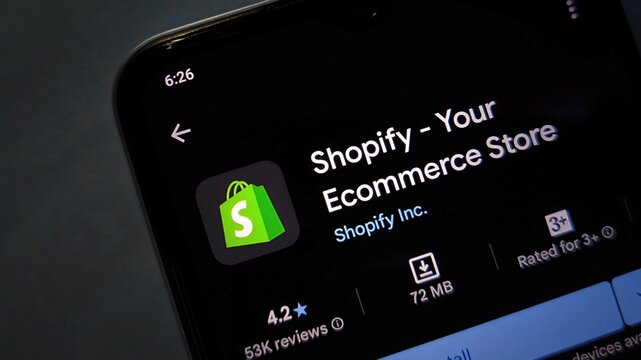 A smartphone screen displaying the Shopify app with a green shopping bag logo