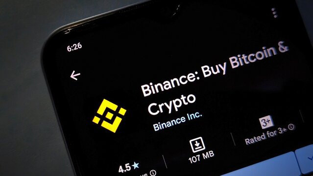 A smartphone screen displaying the Binance app for buying and selling cryptocurrency