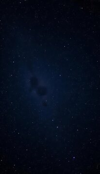 A black void speckled with countless glittering stars and faint nebulae,  abstract,  nebulae